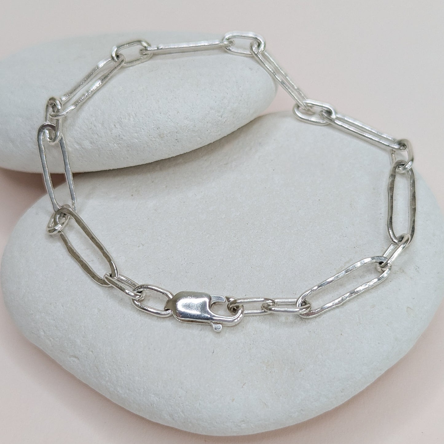 Silver chain bracelet on a stack of white stones