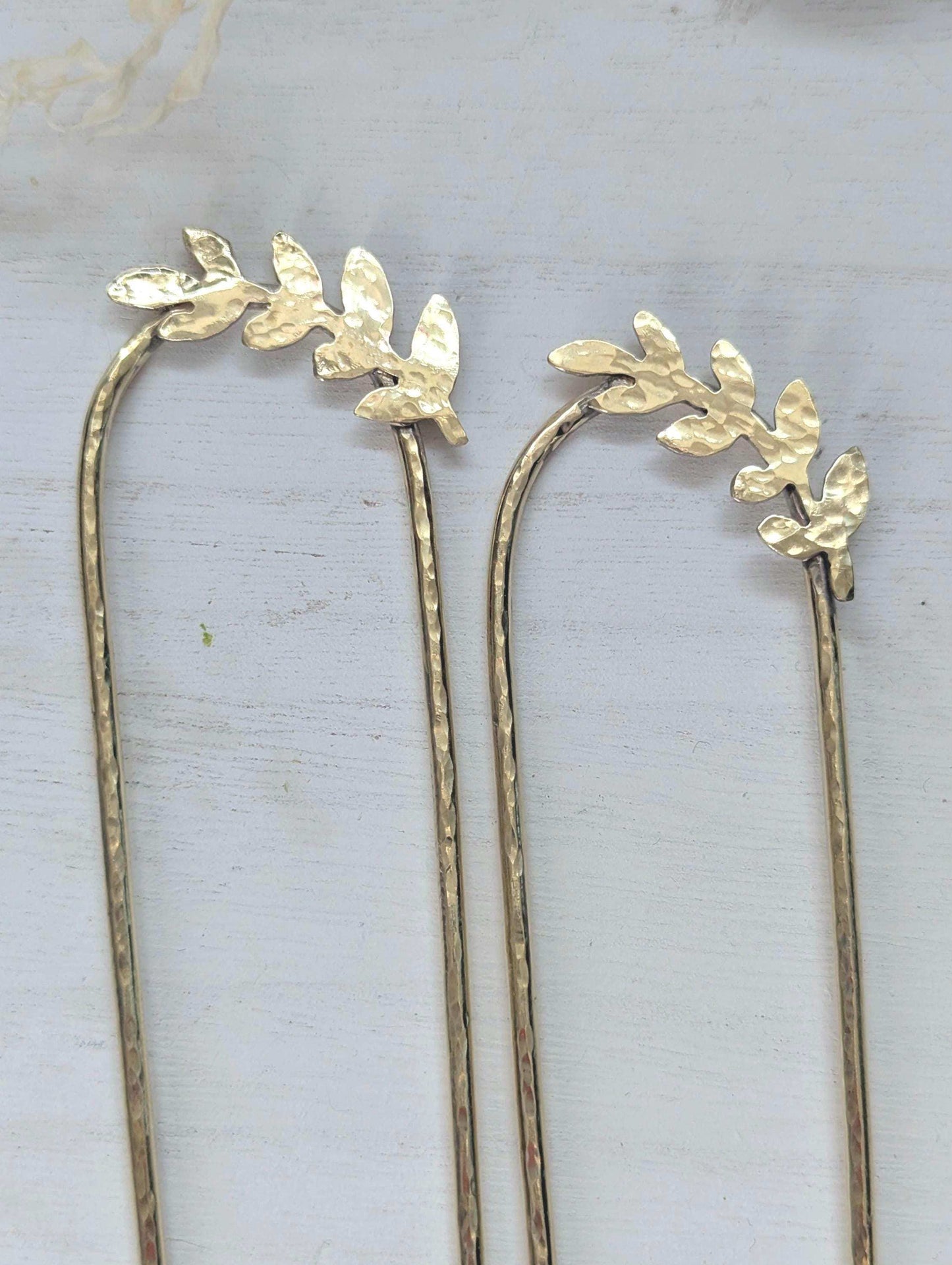 Handcrafted and forged romantic Grecian style laurel leaf rounded hair fork - hammered gold brass laurel leaf is offset to the right at the top of the hair fork