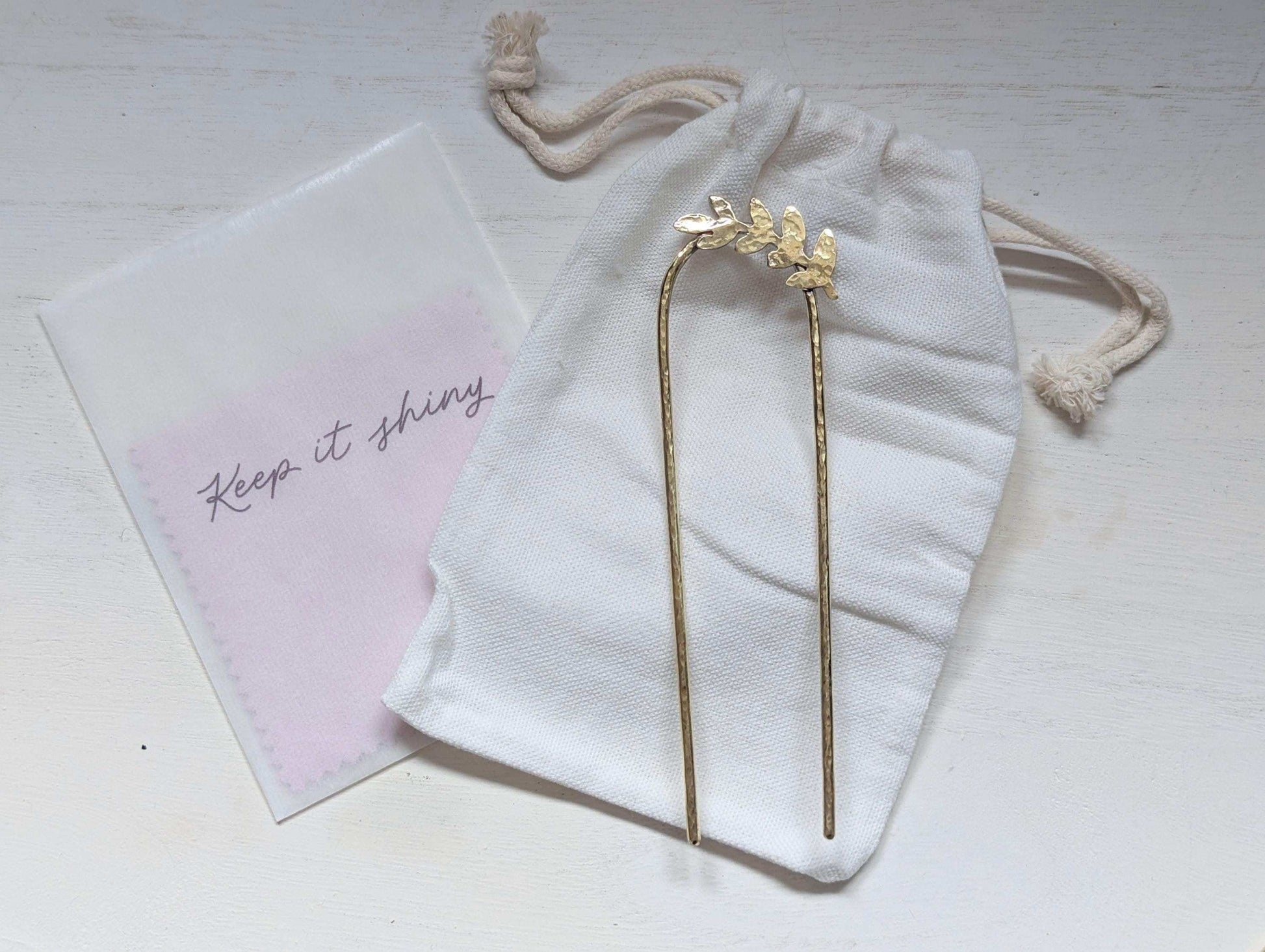 Handcrafted and forged romantic Grecian style laurel leaf rounded hair fork - hammered gold brass laurel leaf is offset to the right at the top of the hair fork - cotton nag and polishing cloths included