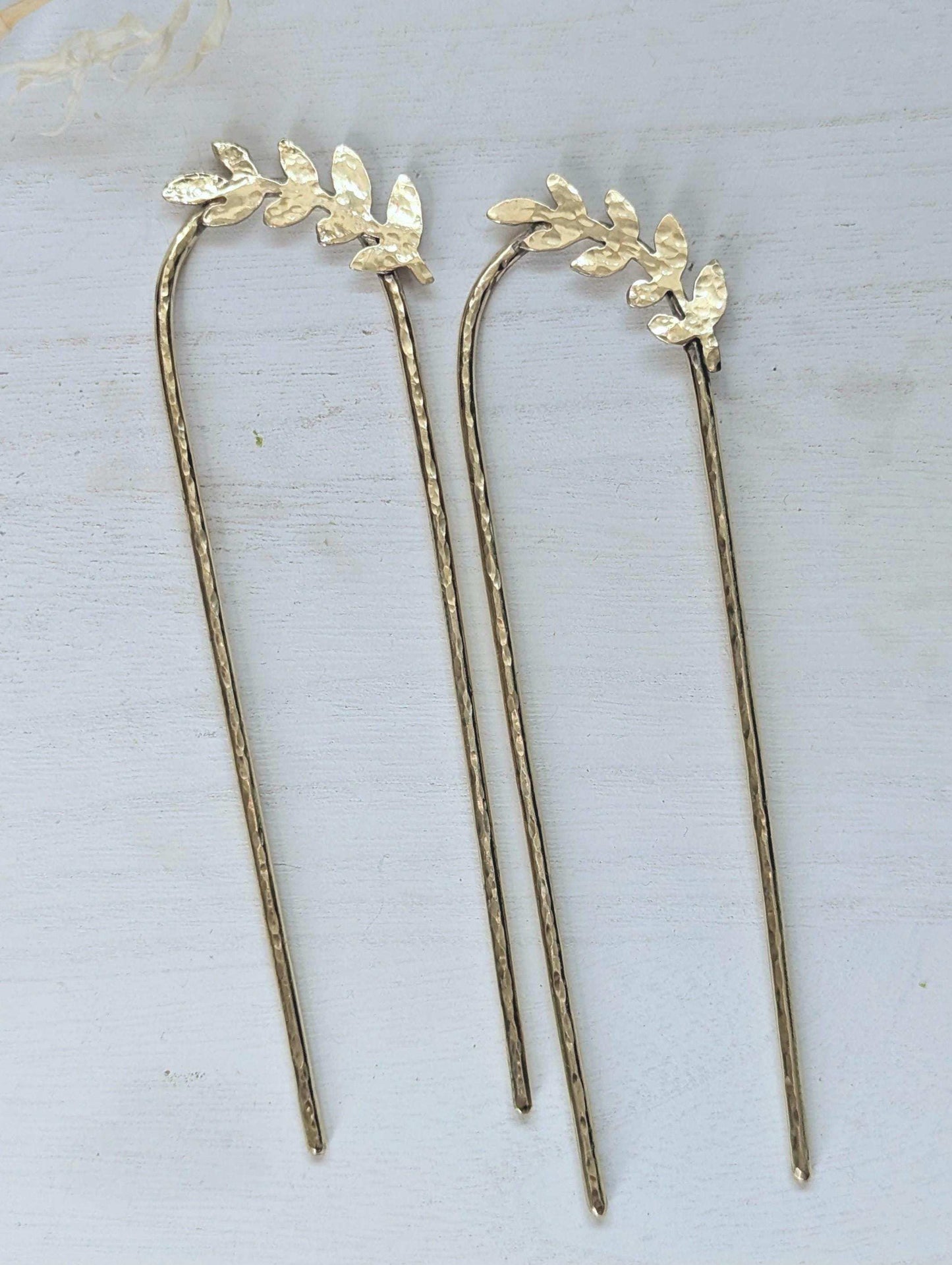 Handcrafted and forged romantic Grecian style laurel leaf rounded hair fork - hammered gold brass laurel leaf is offset to the right at the top of the hair fork