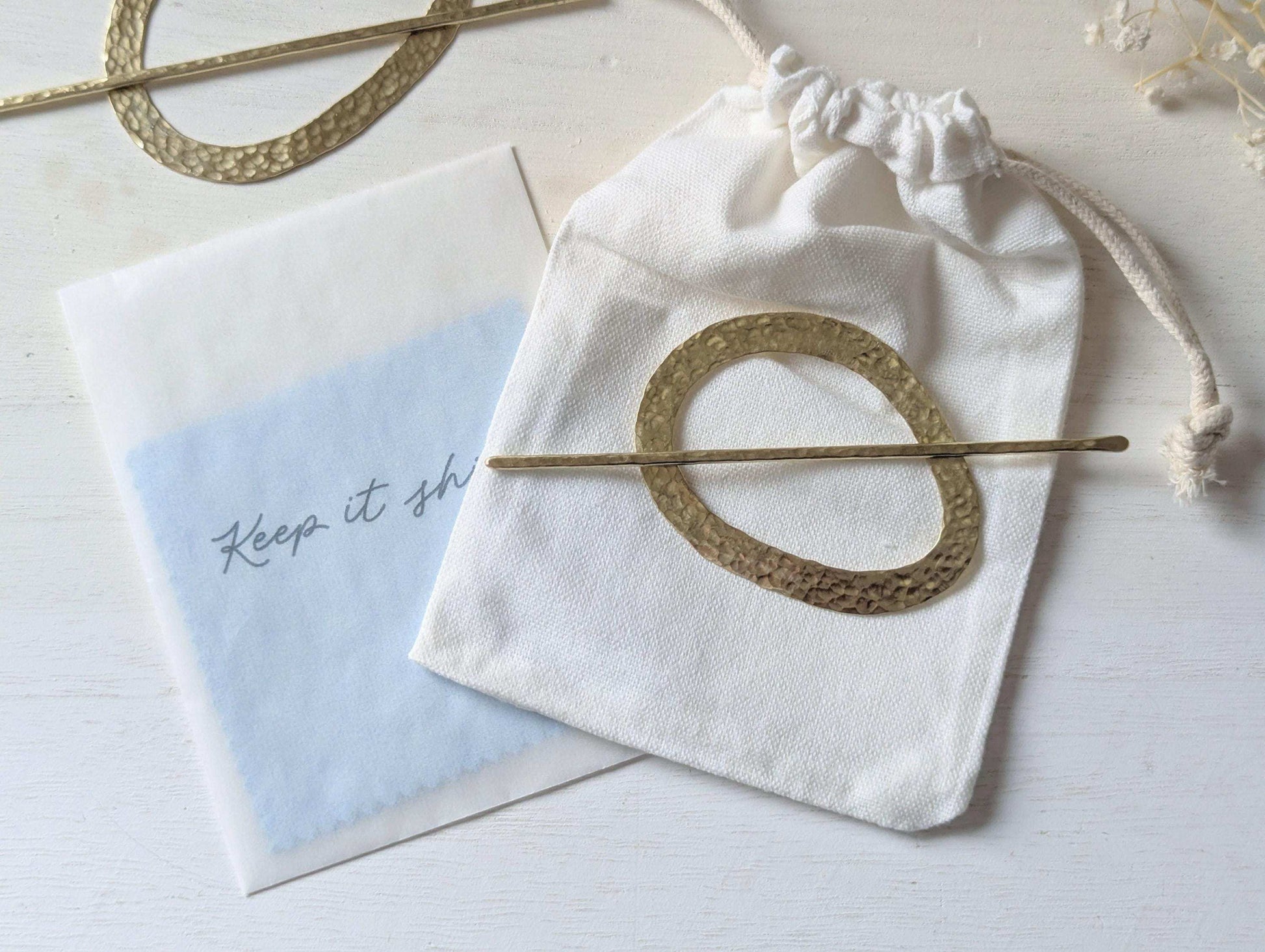 Pebble gold hammered brass round hair stick barrette bun holder - shows cotton bag and polishing cloths