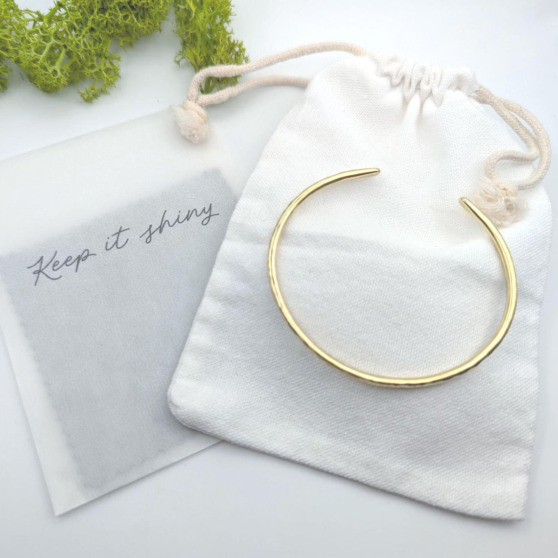 open cuff hammered texture sold brass bangle, is a beautiful sunshine gold colour - showing cotton bag and polishing cloths included
