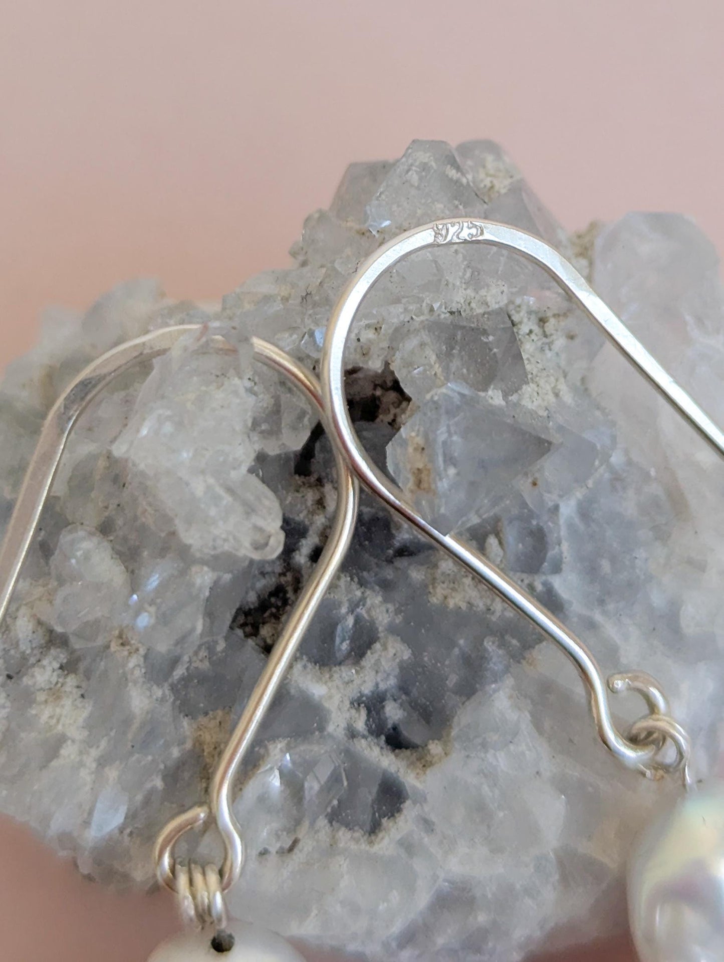 Handcrafted 925 sterling silver genuine large Baroque pearl drop earrings worn on a modern arched sterling silver ear wire