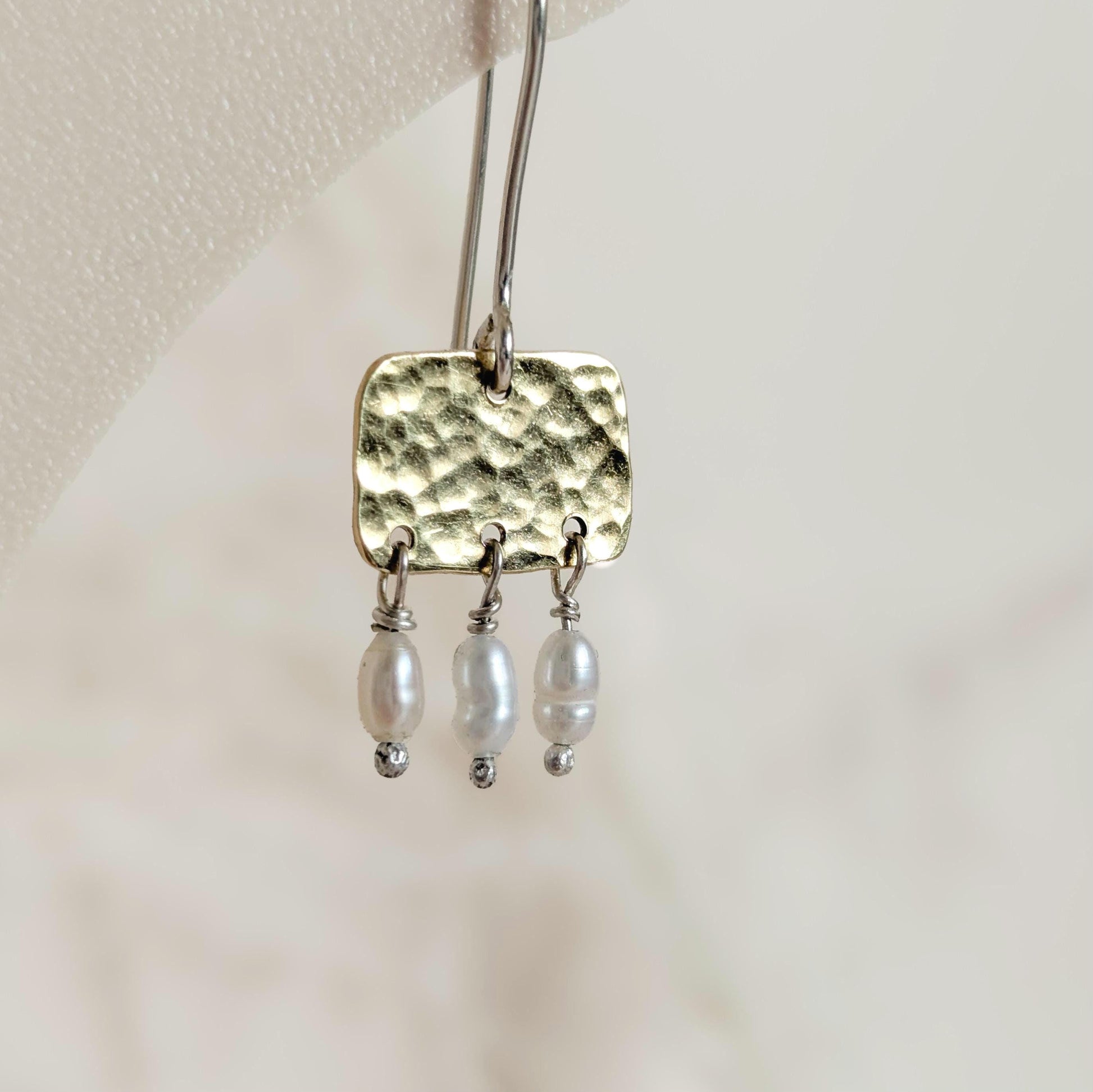 Roman style hammered brass gold squares with 3 seed pearl droplets hanging from each square | 925 Sterling Silver ear wires - mixed metals - close up of hammered texture