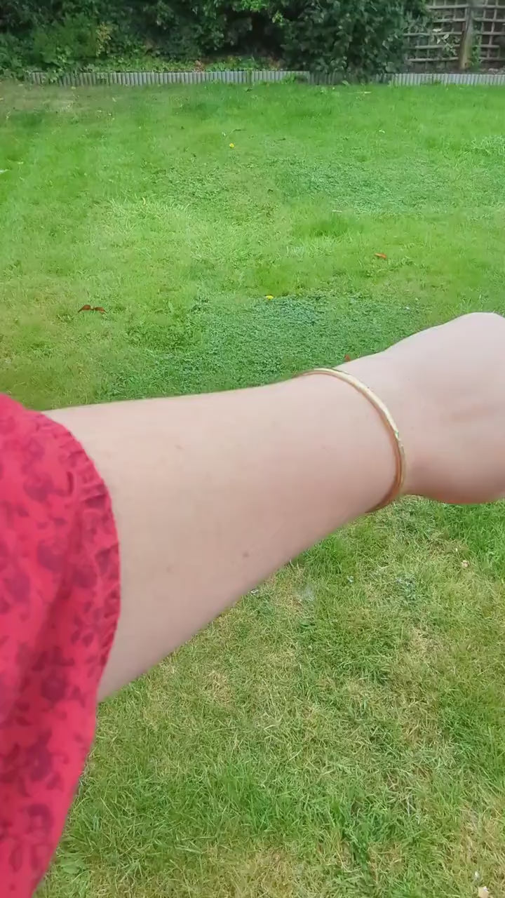 open cuff hammered texture sold brass bangle, is a beautiful sunshine gold colour - shown being worn