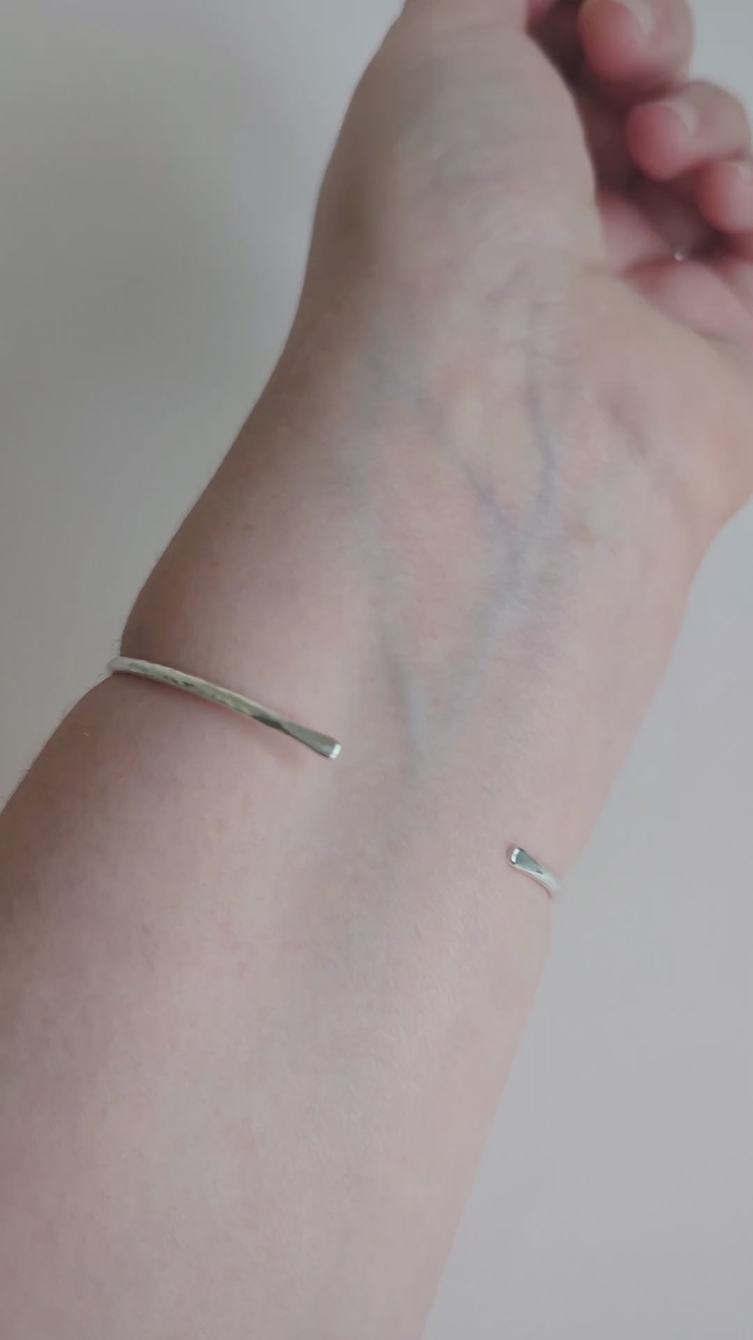 slim hammered textured silver cuff bangle being worn on wrist