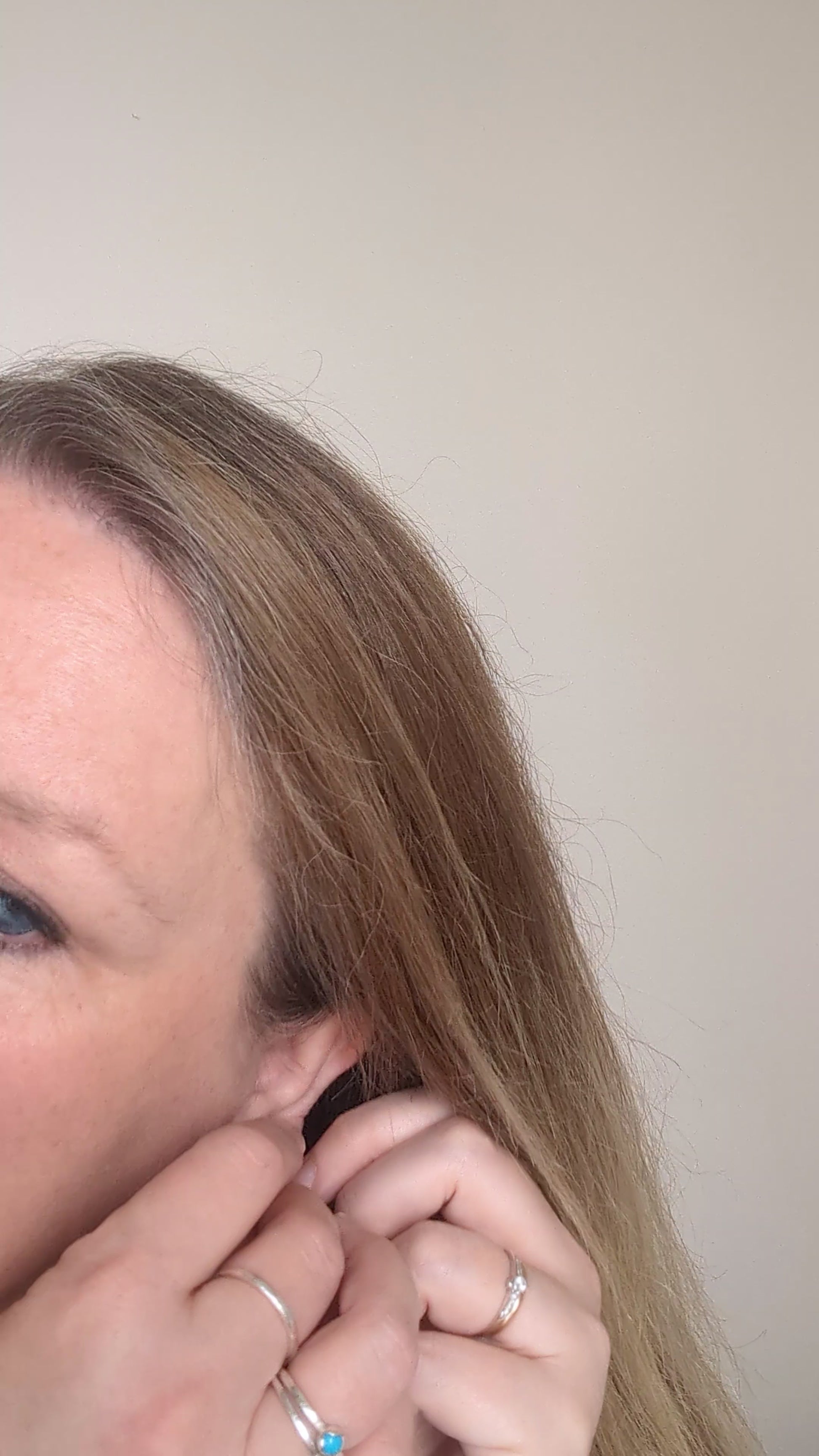 Dainty freshwater seed pearl dangle cascade drop earrings in Sterling silver - shown being worn on ear lobe