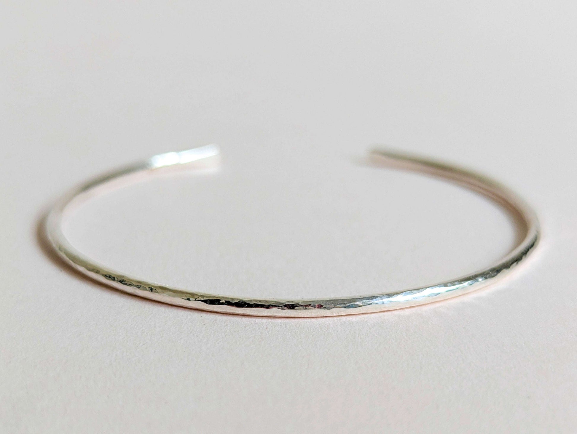 Silver bracelet on a light gray background