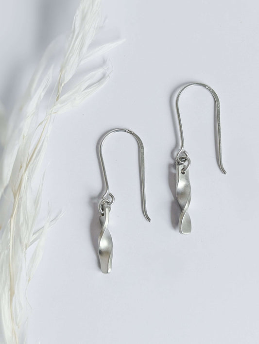 Minimalist satin brushed sterling silver twist drop earrings - top down view
