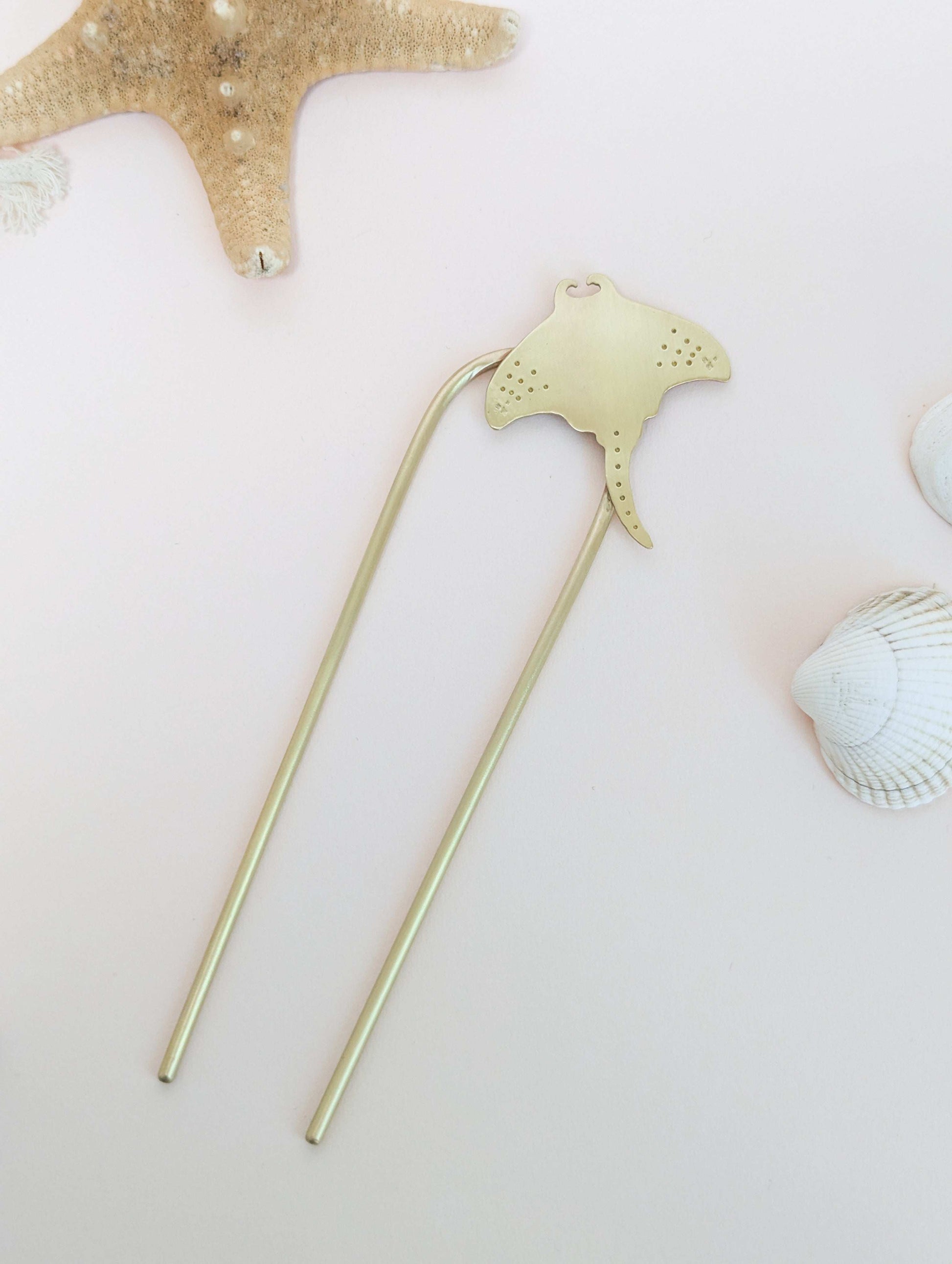 Manta Ray U Pin French hair fork in a brushed brass satin finish - top down view, Manta ray secured on the top right of the hair fork with dot and star details on the pectoral fins