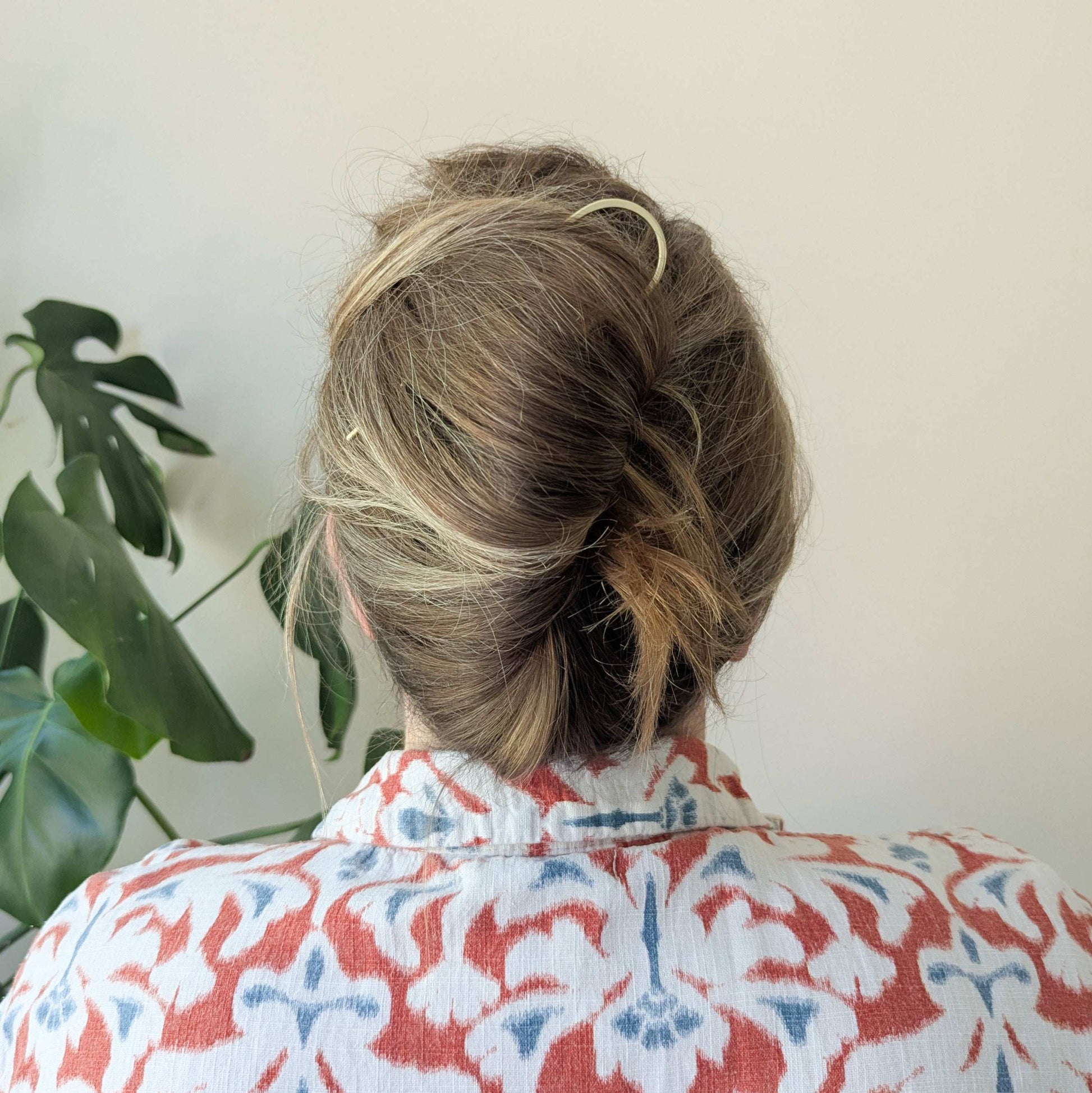 Brushed brass gold round pin hair fork - worn  in the hair to secure a french twist