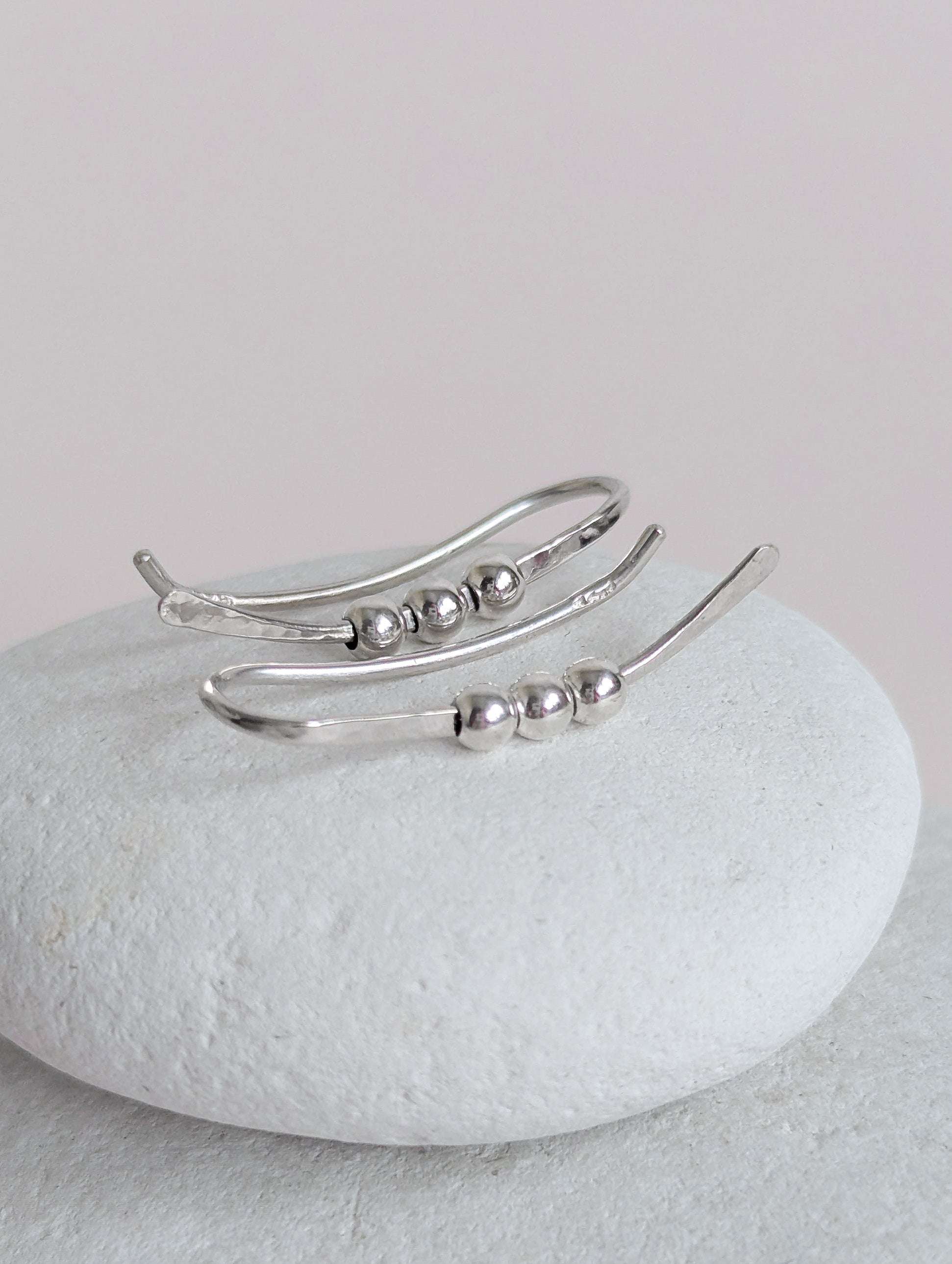 Silver  bead ear climber with beads on a white stone