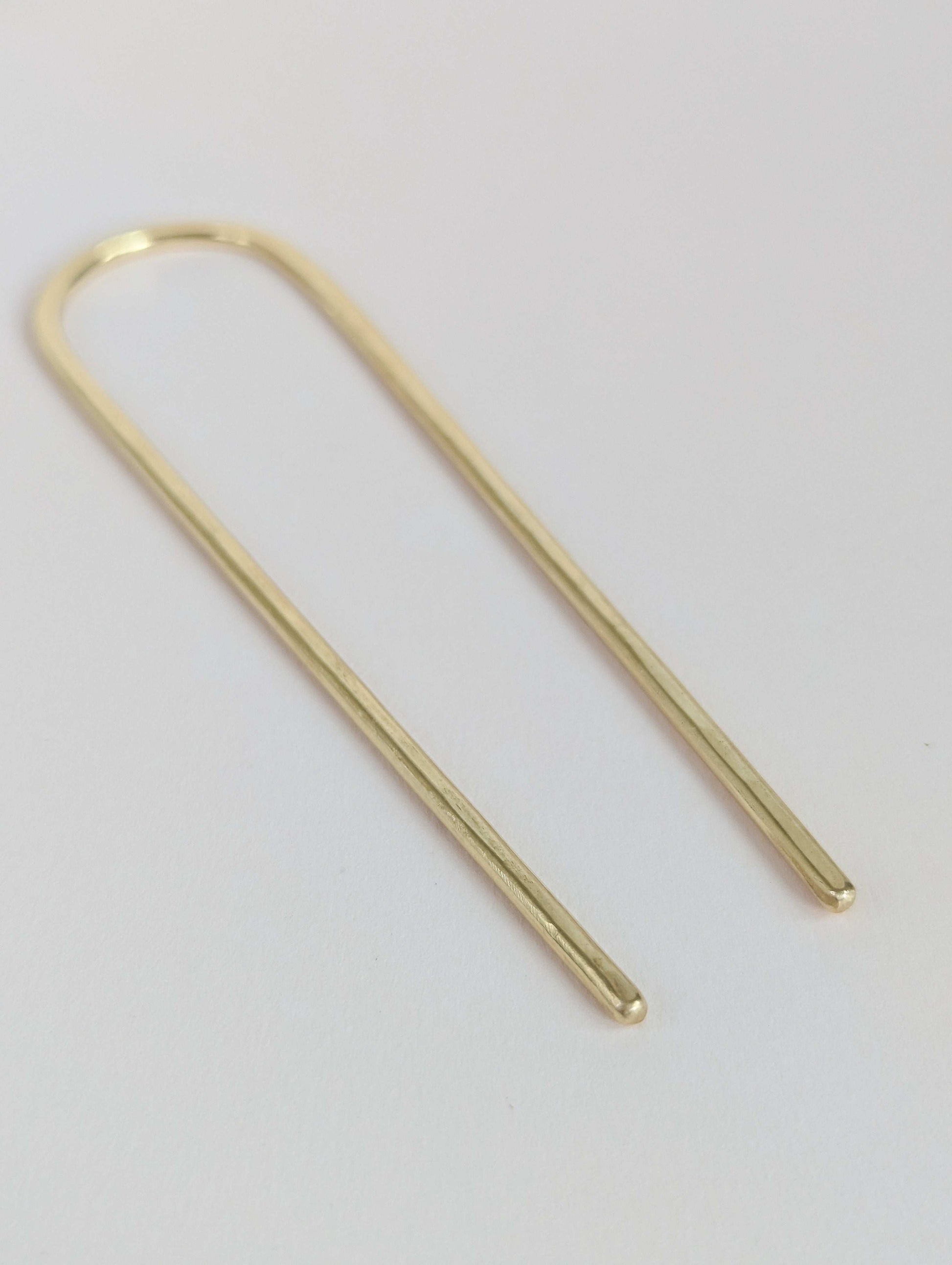 gold round hair fork on white background