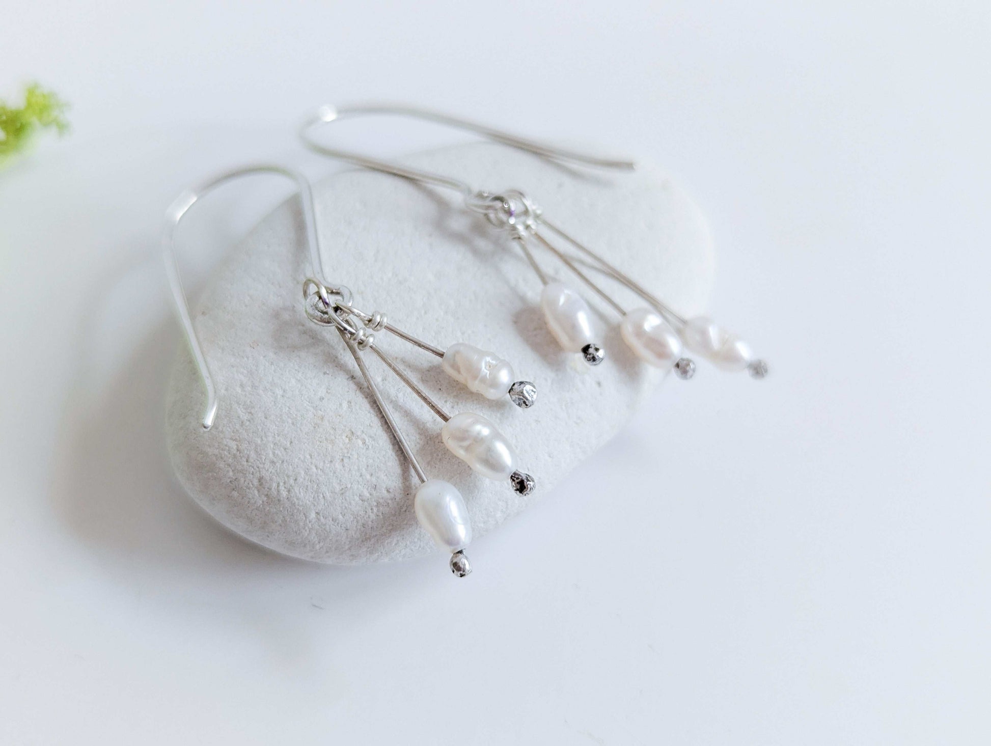 Dainty freshwater seed pearl dangle cascade drop earrings in Sterling silver - side view, close up of seed pearl drops