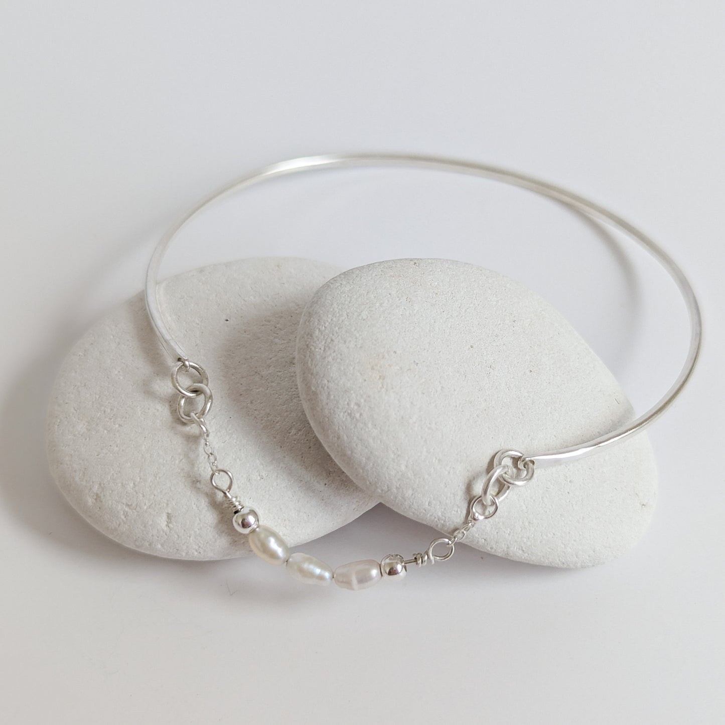 Thin sterling silver dainty cuff bangle with seed pearl bar chain - shows laid flat