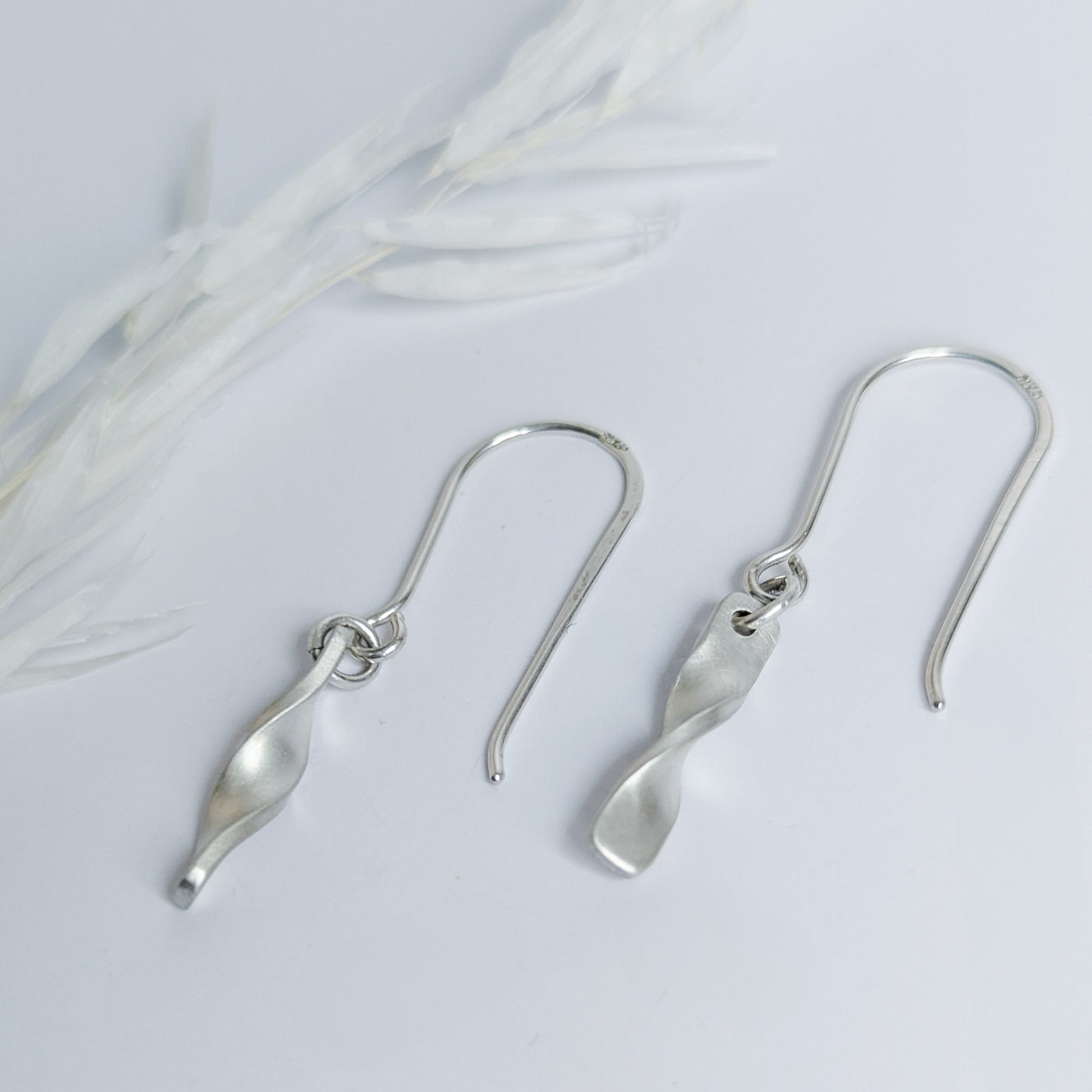Minimalist satin brushed sterling silver twist drop earrings- side vew