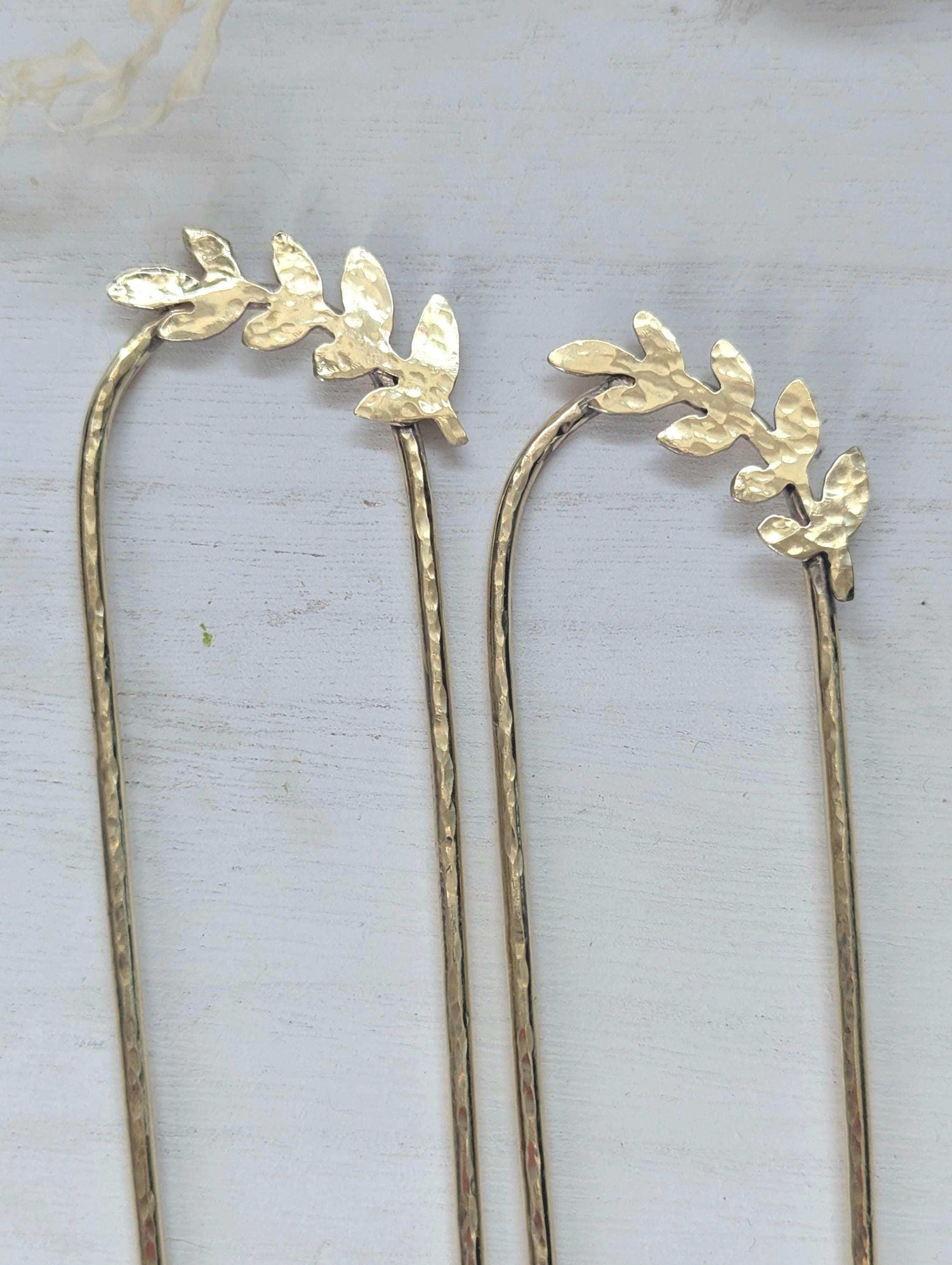 Handcrafted and forged romantic Grecian style laurel leaf rounded hair fork - hammered gold brass laurel leaf is offset to the right at the top of the hair fork