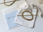 Pebble gold hammered brass round hair stick barrette bun holder - shows cotton bag and polishing cloths