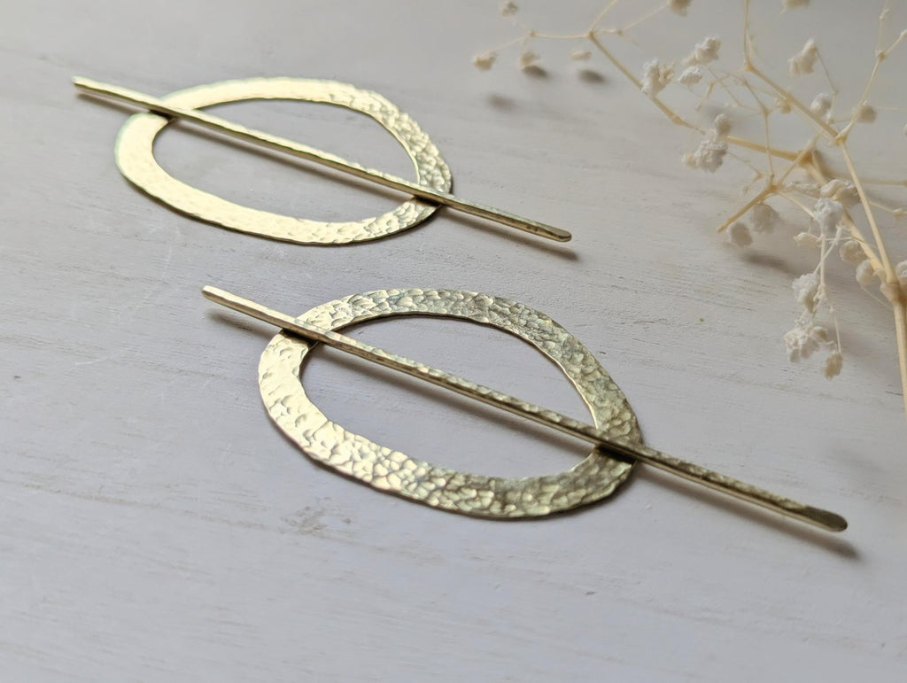 Pebble gold hammered brass round hair stick barrette bun holder - close up of the hammered texture on the pin and pebble shaped barrette