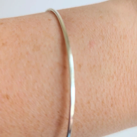 Thin sterling silver dainty cuff bangle with seed pearl bar chain - show bangle being worn
