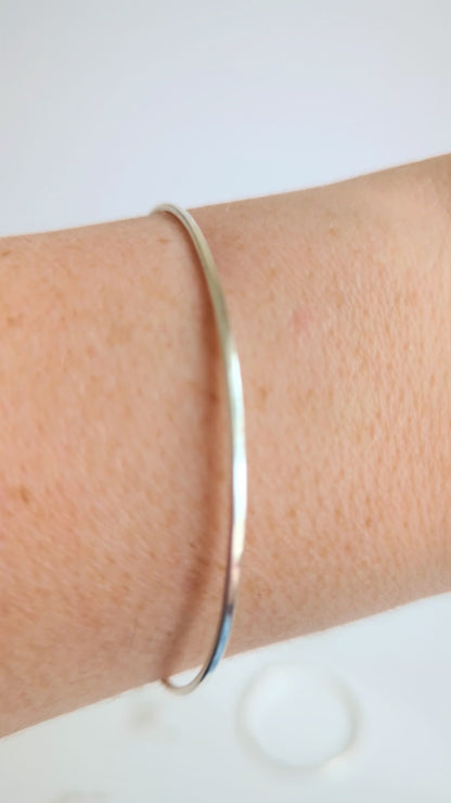 Thin sterling silver dainty cuff bangle with seed pearl bar chain - show bangle being worn