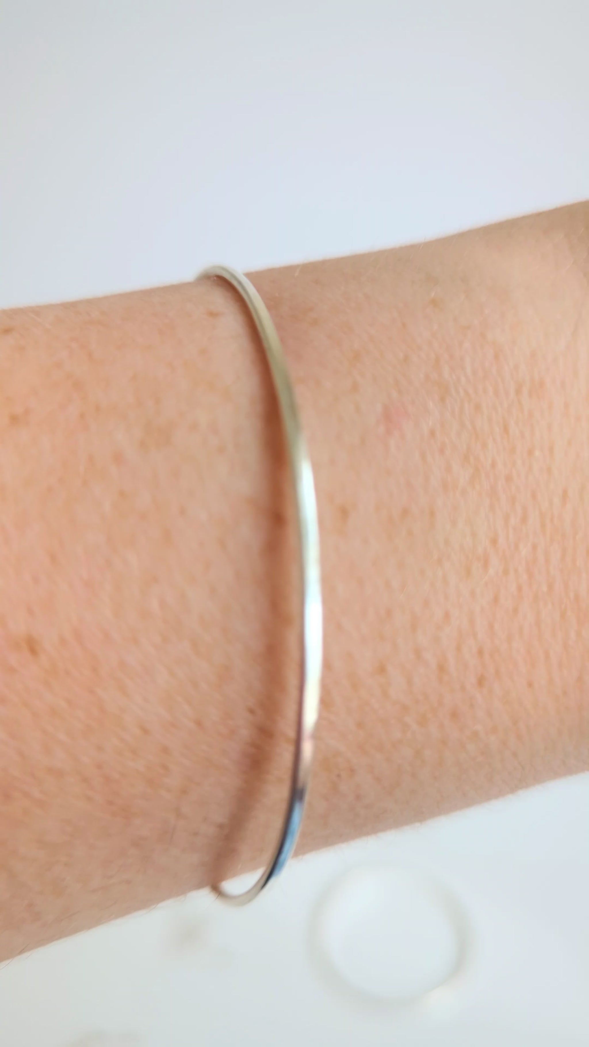 Thin sterling silver dainty cuff bangle with seed pearl bar chain - show bangle being worn