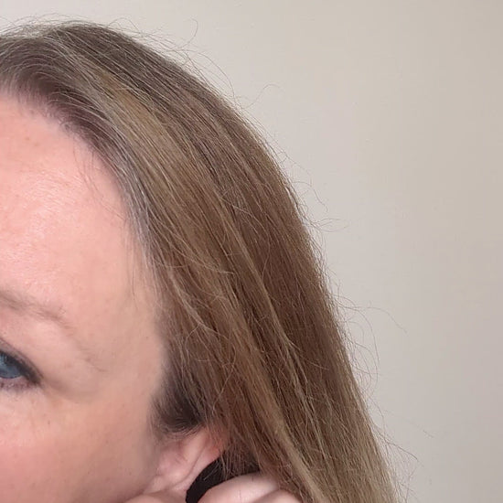 Dainty freshwater seed pearl dangle cascade drop earrings in Sterling silver - shown being worn on ear lobe
