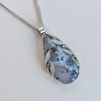 Necklace with a pendant featuring a natural stone design on a light background