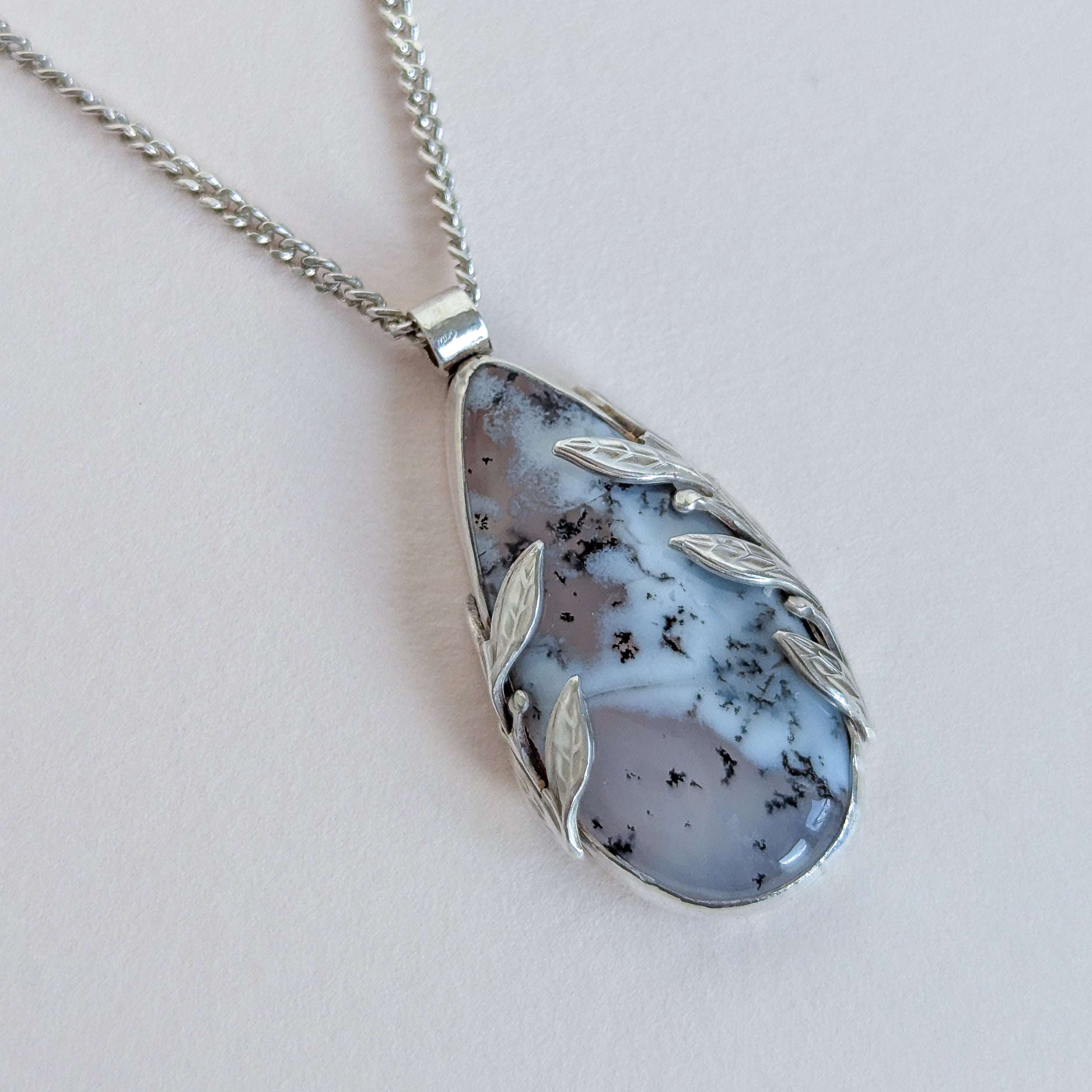 Necklace with a pendant featuring a natural stone design on a light background