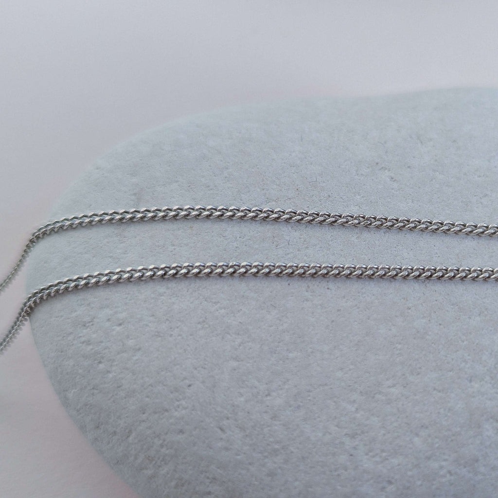 Silver chain on a white stone