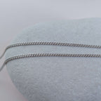 Silver chain on a white stone