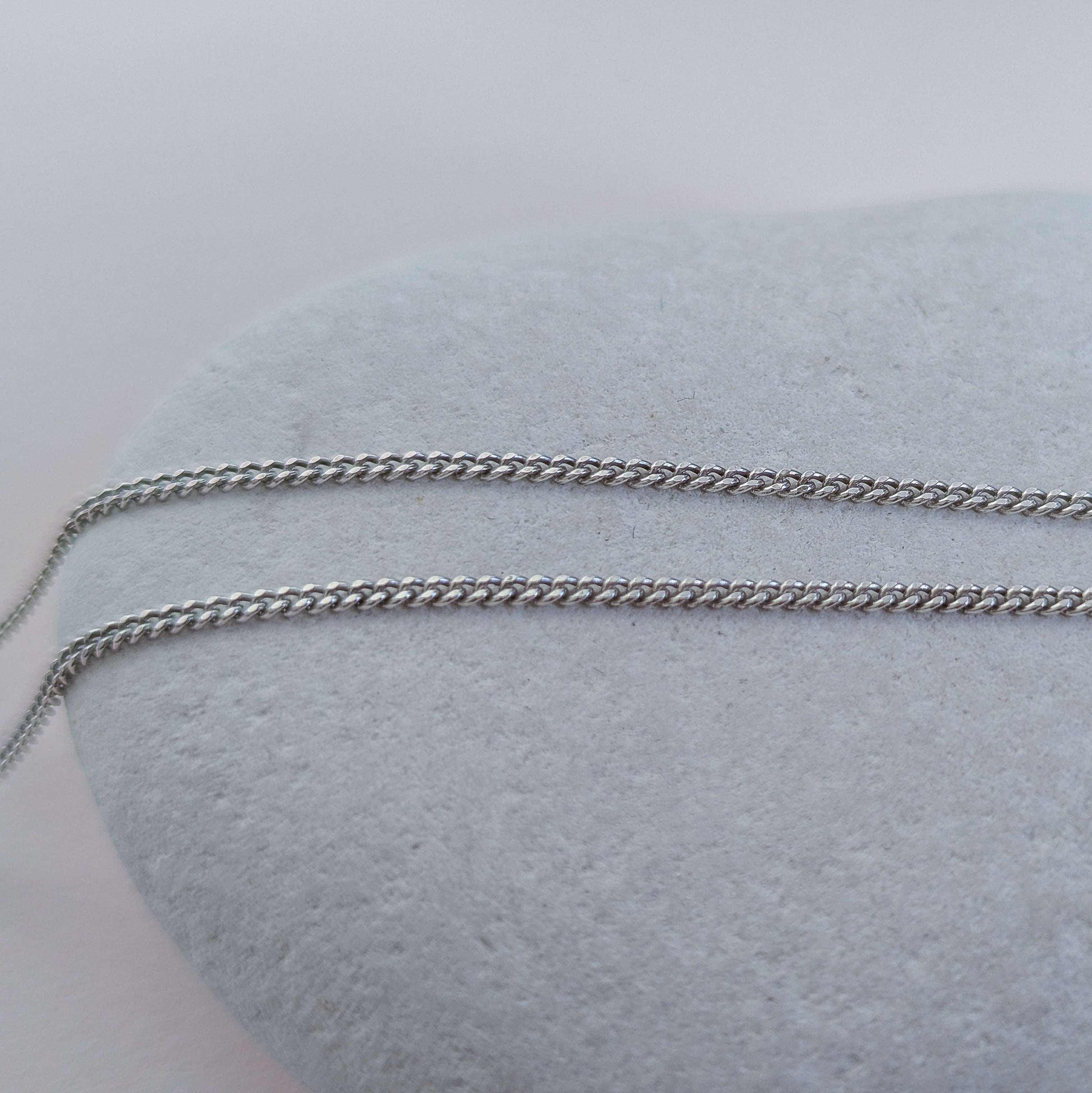 Silver chain on a white stone