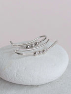Silver  bead ear climber with beads on a white stone