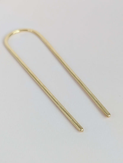 gold round hair fork on white background