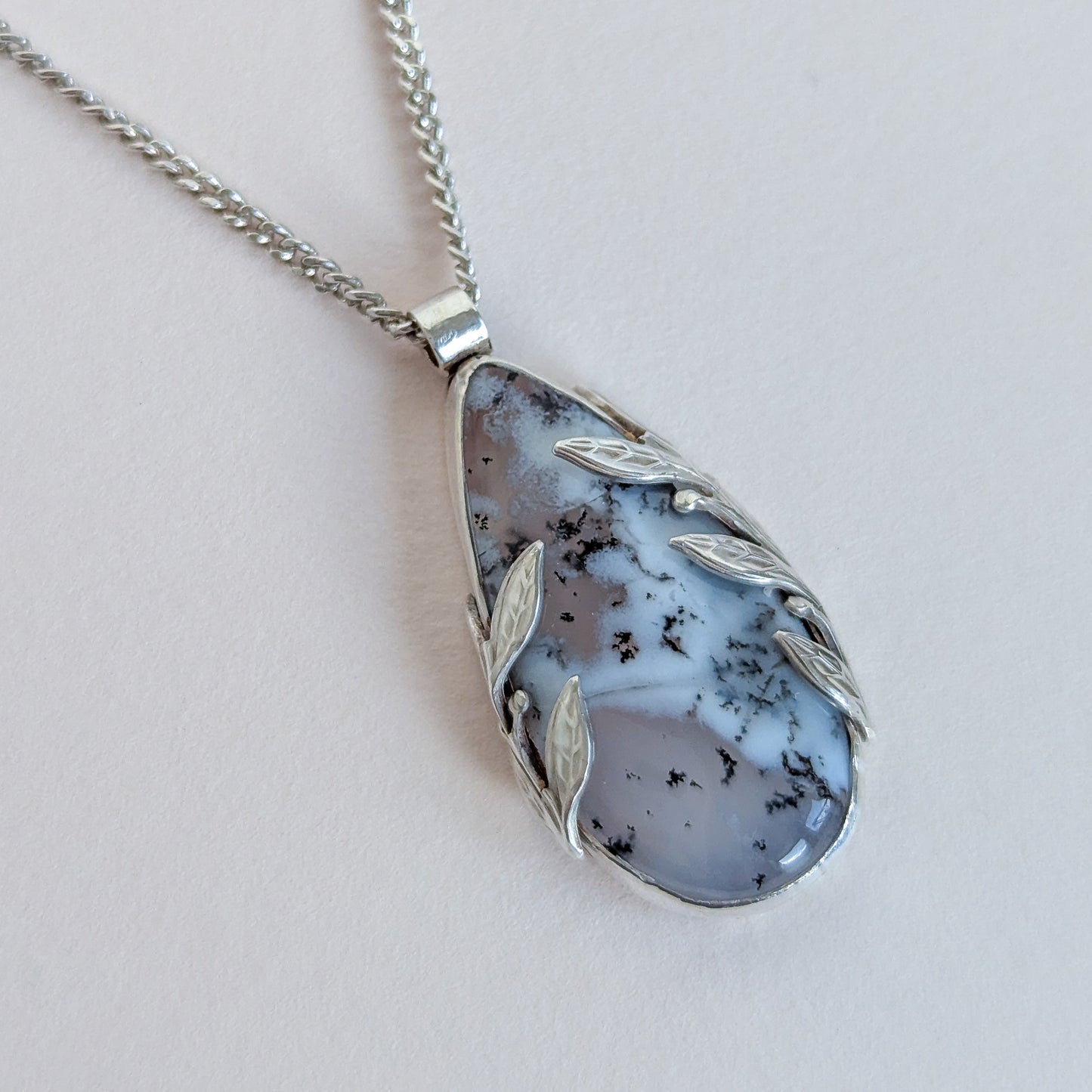 Necklace with a pendant featuring a natural stone design on a light background