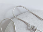 Dainty freshwater seed pearl dangle cascade drop earrings in Sterling silver - close up on 925 stamp on ear wire