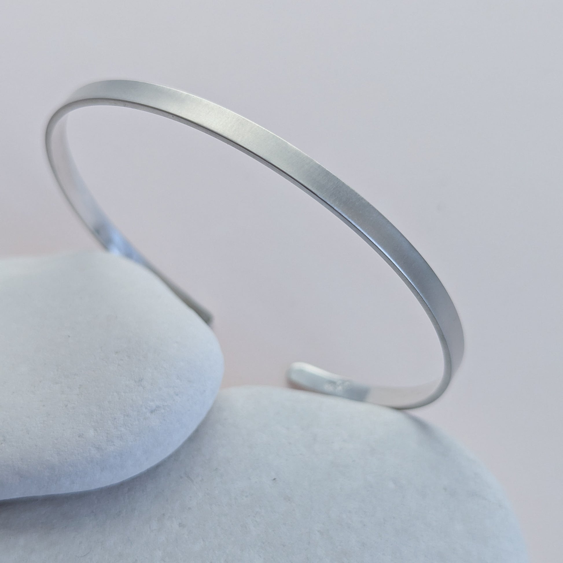 brushed Silver bracelet on a light grey background