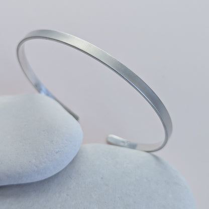 brushed Silver bracelet on a light grey background