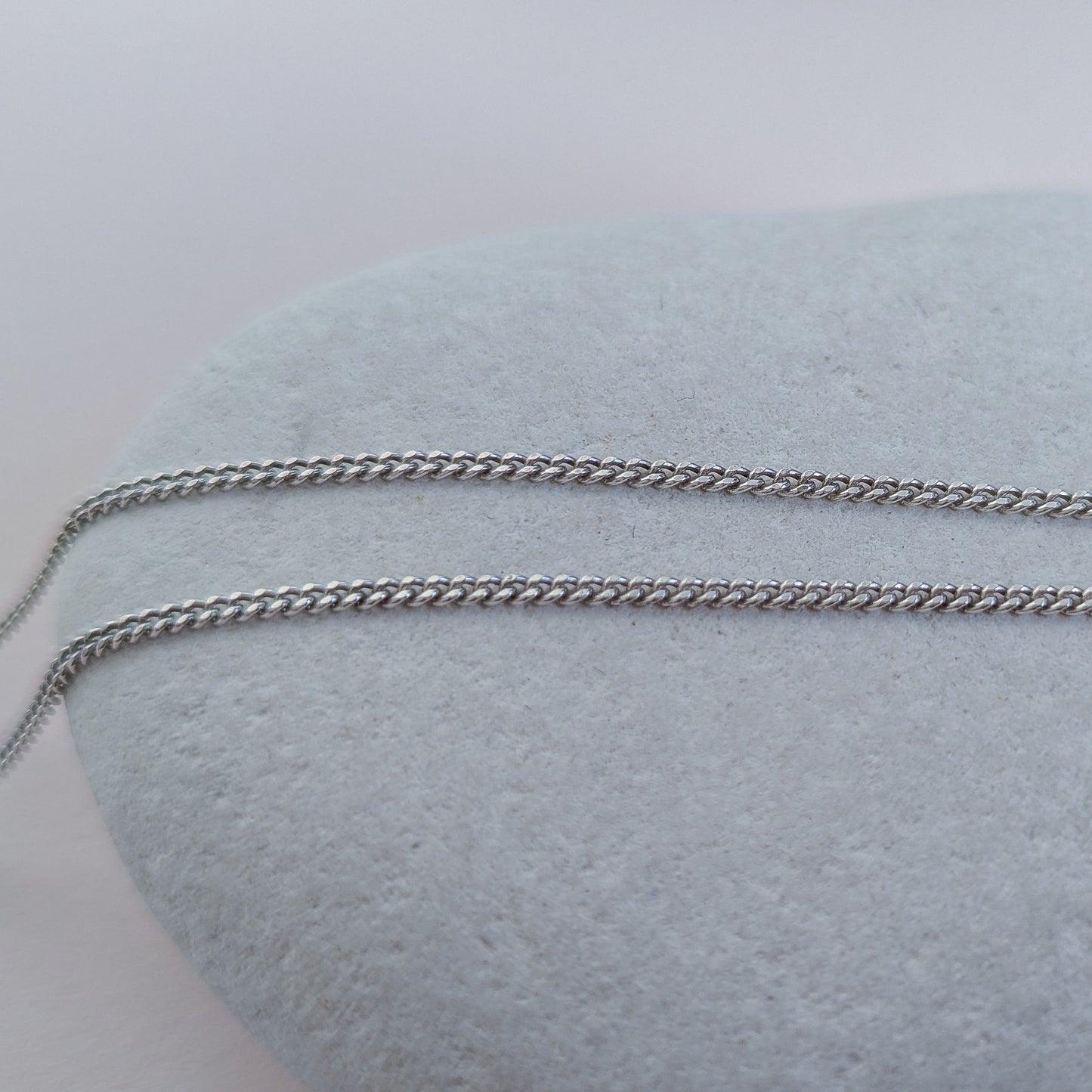 Silver chain on a white stone