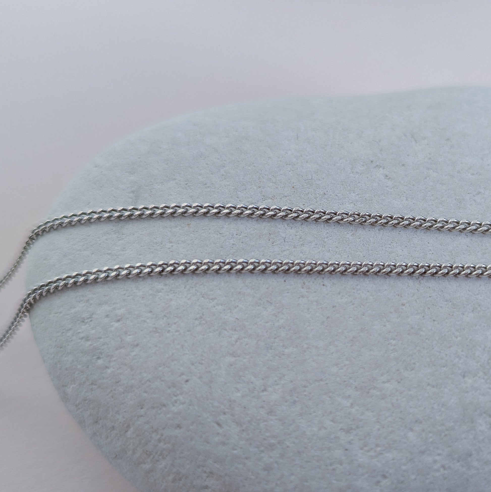 Silver chain on a white stone