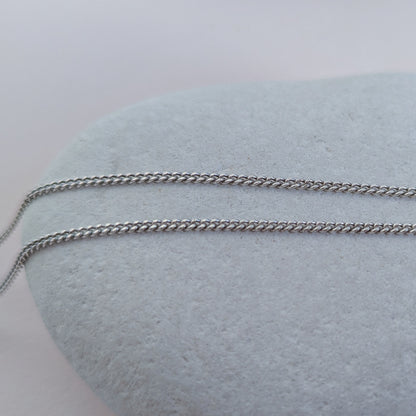 Silver chain on a white stone