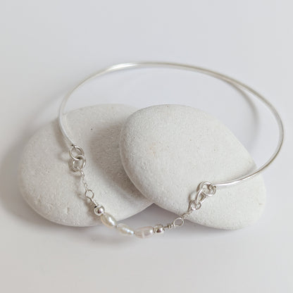Thin sterling silver dainty cuff bangle with seed pearl bar chain - shows laid flat