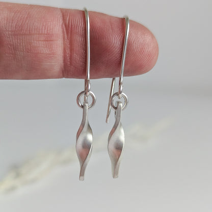 Minimalist satin brushed sterling silver twist drop earrings - close up 