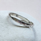 Sterling Silver ring with hand stamped star pattern on a light gray stone surface