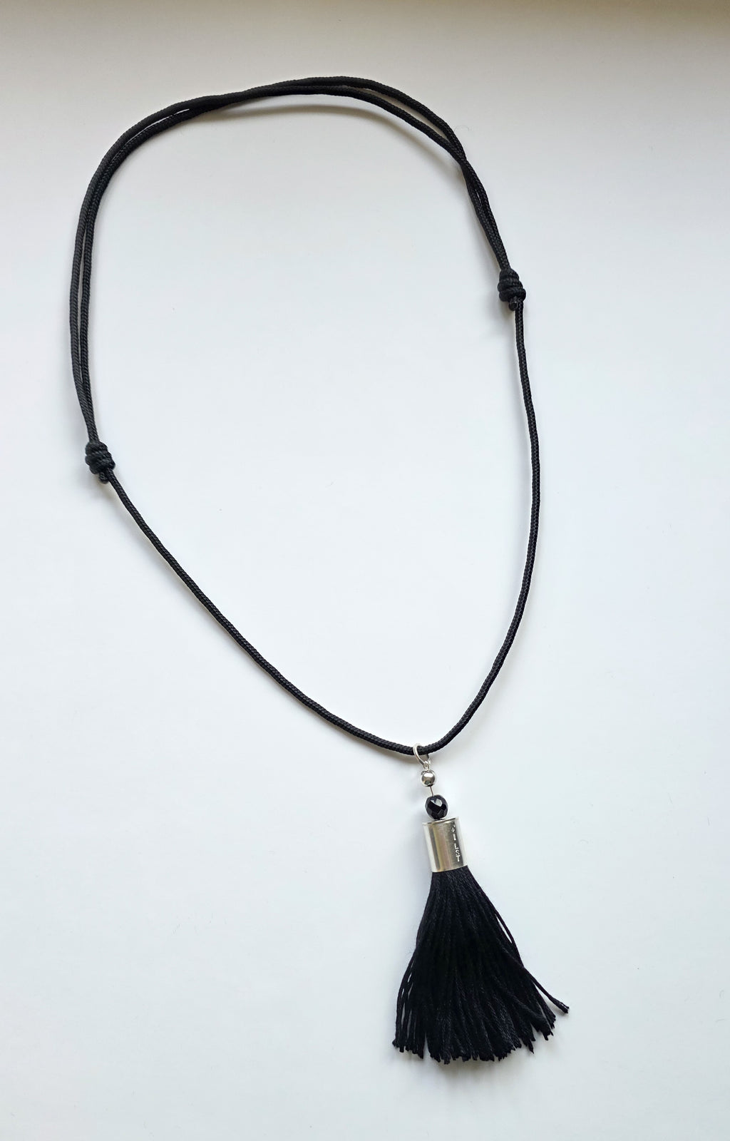 hand crafted sterling silver & black french jet tassel cord necklace white background