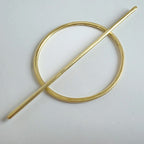 Gold brass hair barrette  on a light grey background