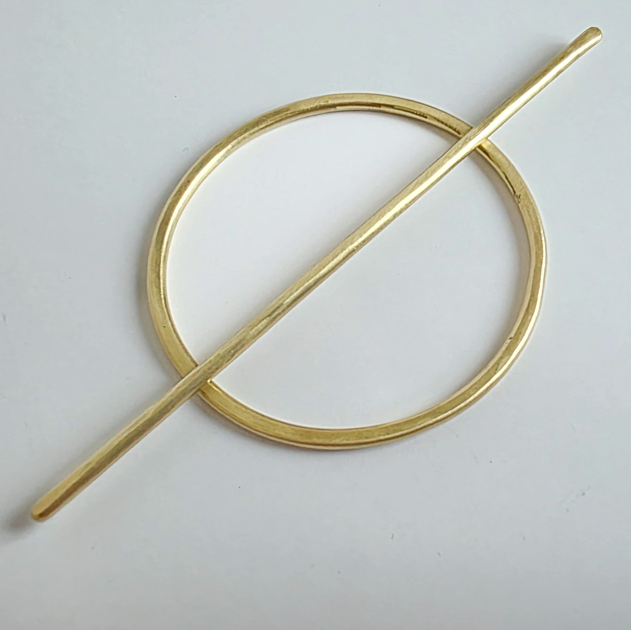 Gold brass hair barrette  on a light grey background