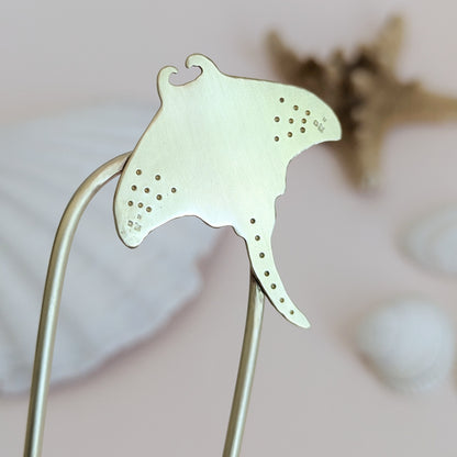 Manta Ray U Pin French hair fork in a brushed brass satin finish - close up of Manta ray secured on the top right of the hair fork with dot and star details on the pectoral fins